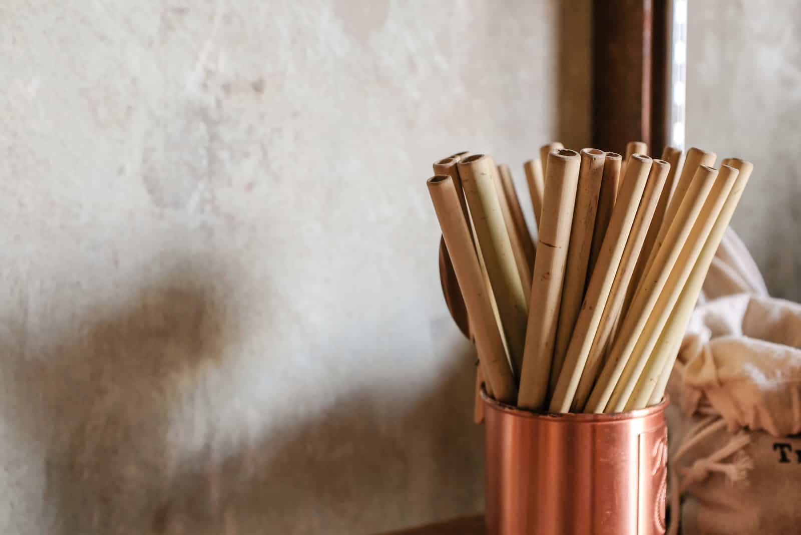 bamboo straws in a rose gold pot