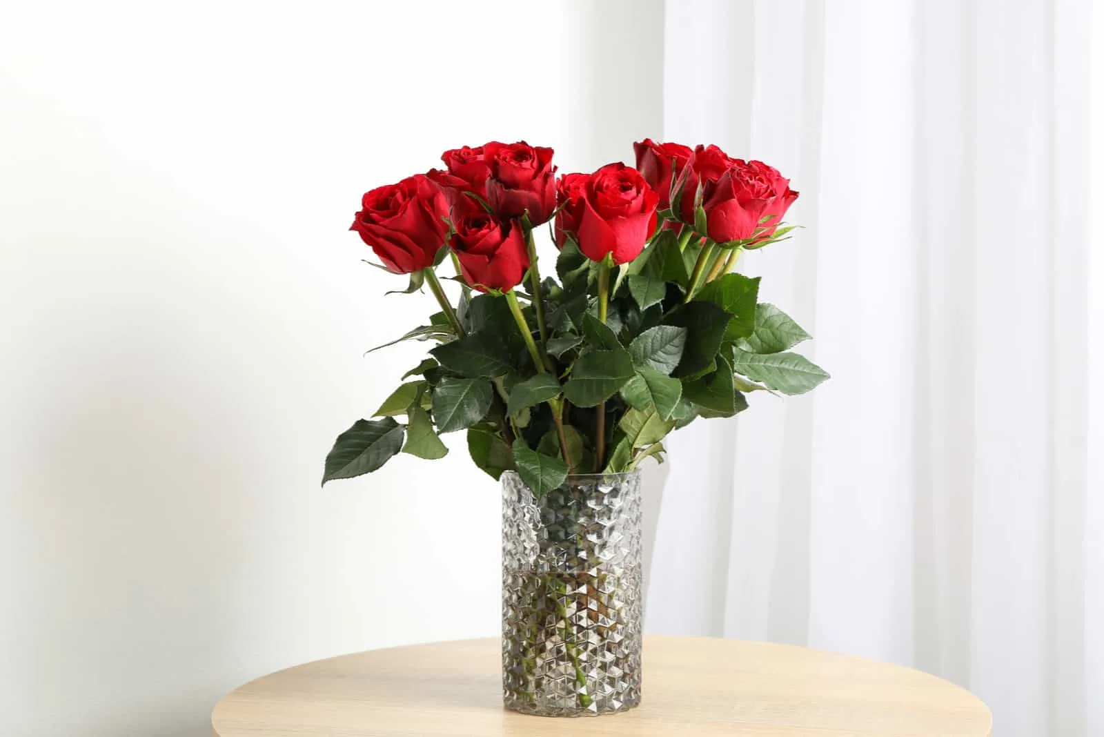 red roses in vase on the table