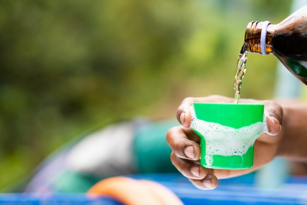 A man pours Humic acid into a container.