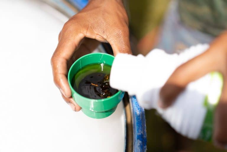 man pouring Humic Acid in cap