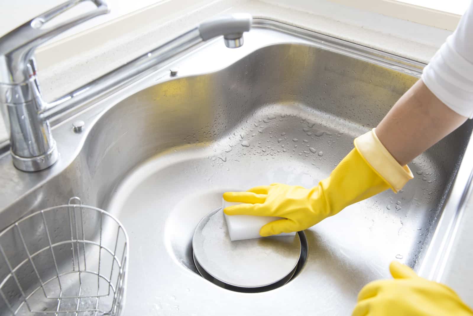 woman cleaning kitchen sink