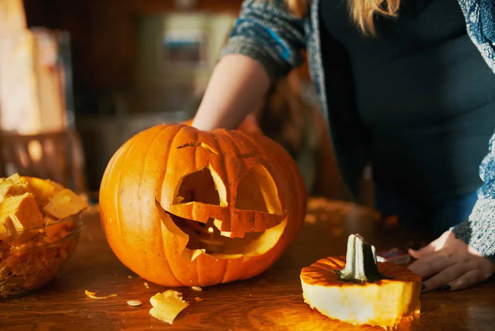 woman decorates a pumpkin
