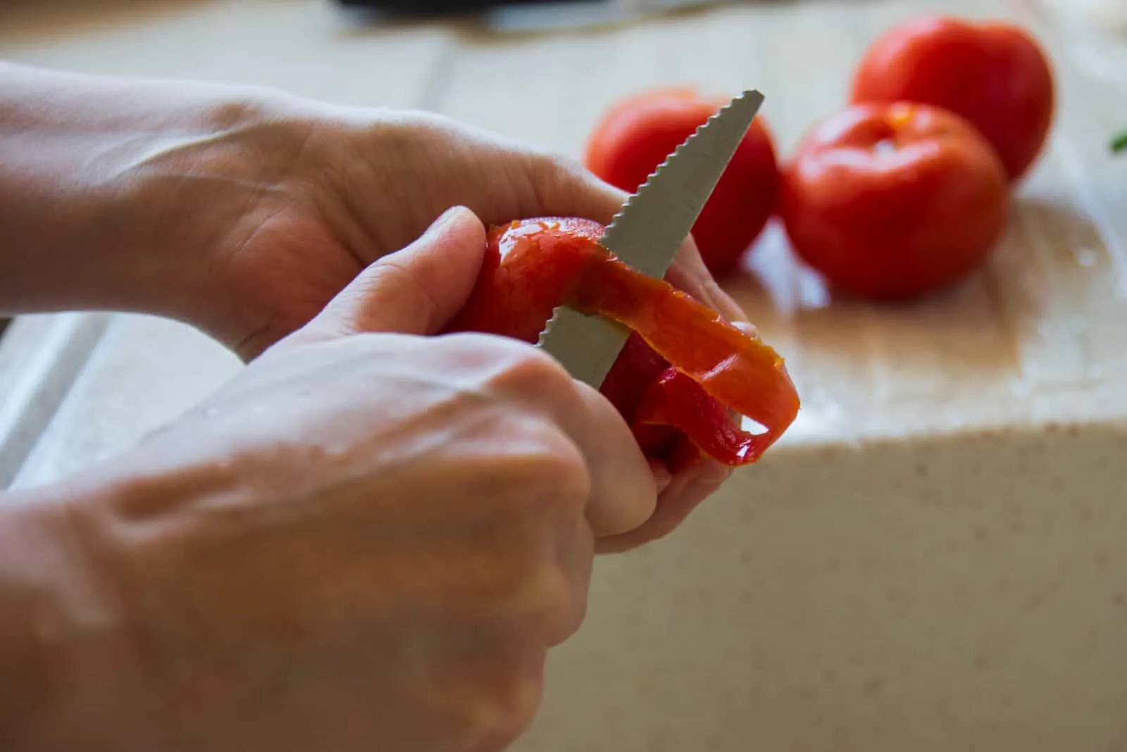 woman peeling tomatoes