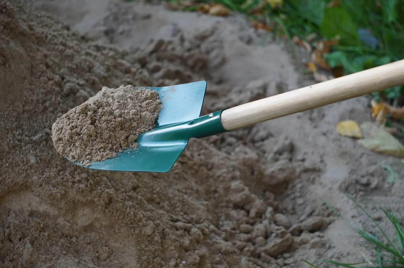 person shoveling sand