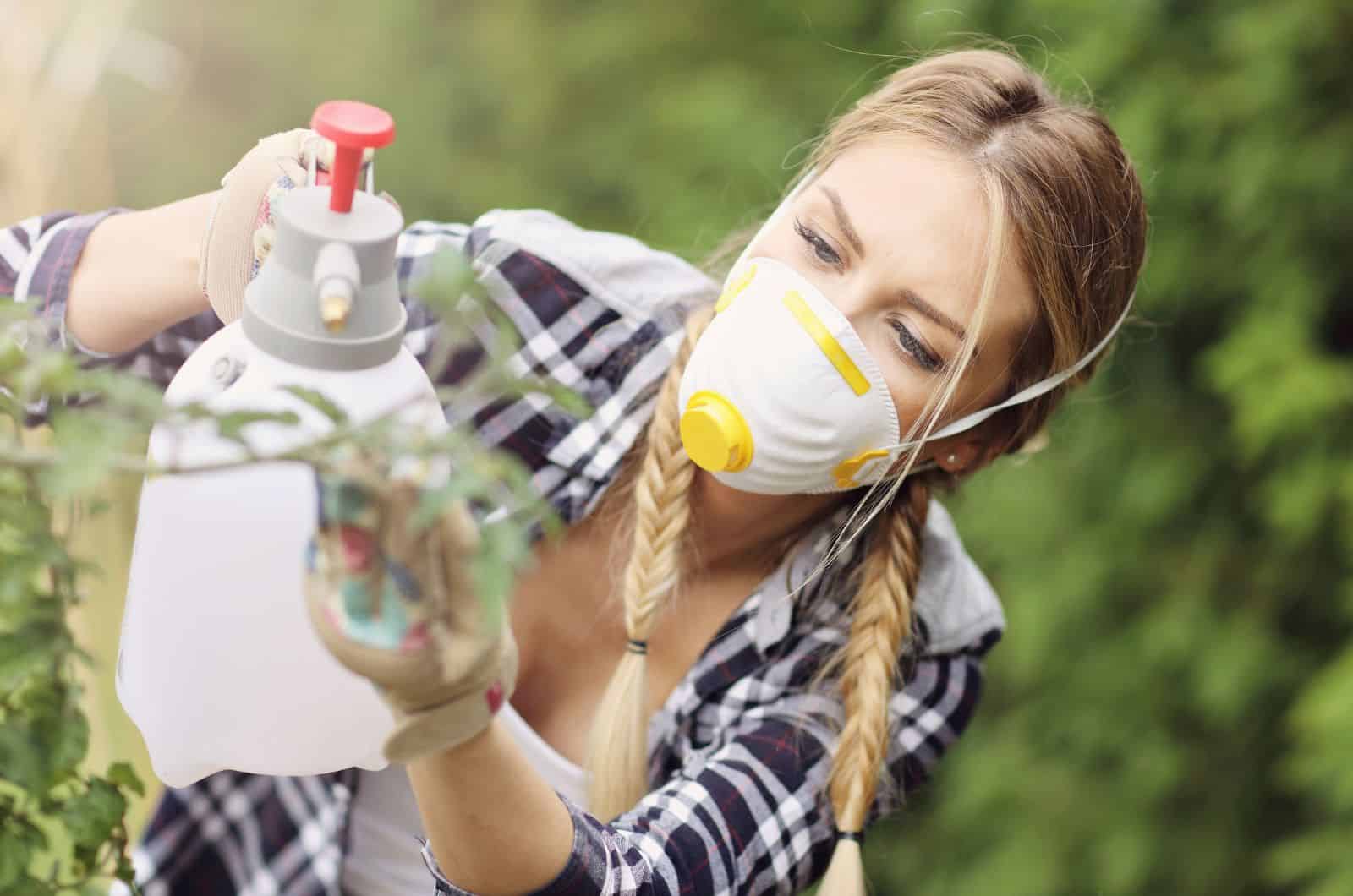 girl spraying plant
