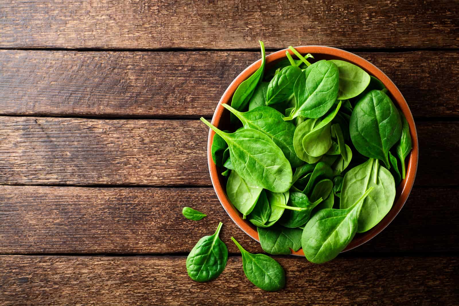 spinach in a wooden bowl