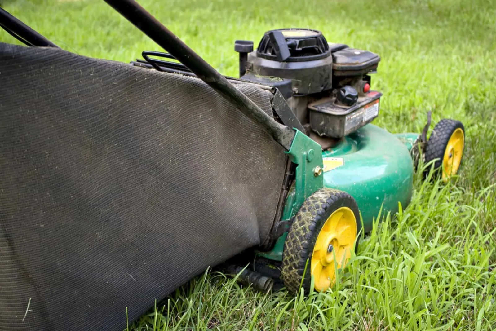 A modern lawn mower cutting through the grass.