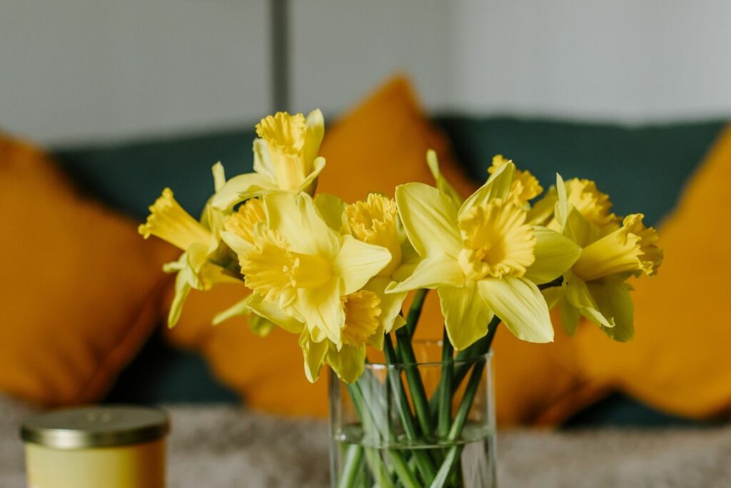 a bouquet of daffodils in a pot on the table