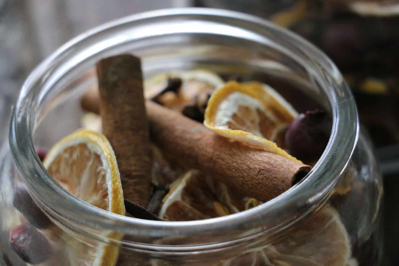 Christmas Potpourri in a glass jar with cinnamon, lemon, cranberries, cloves and anise