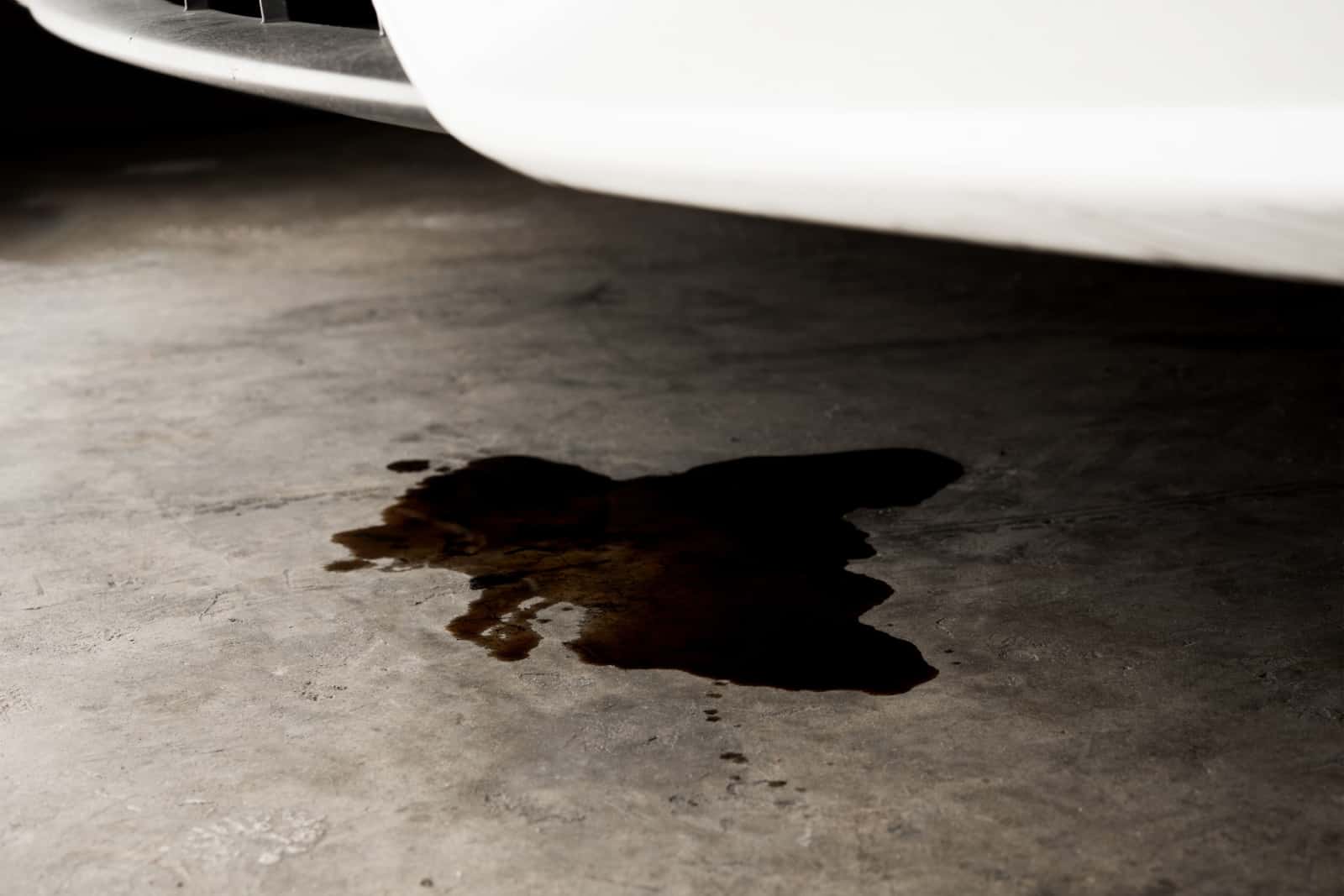 Oil leak or drop from engine of car on concrete floor