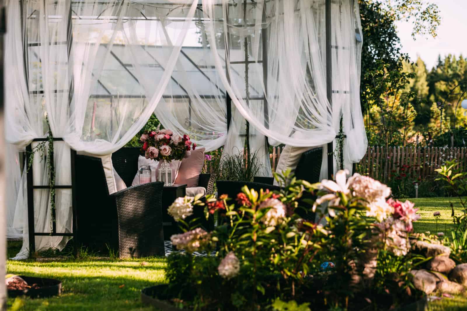 Summer canopy gazebo and flowerbeds, scandinavian style, romantic style in swedish garden