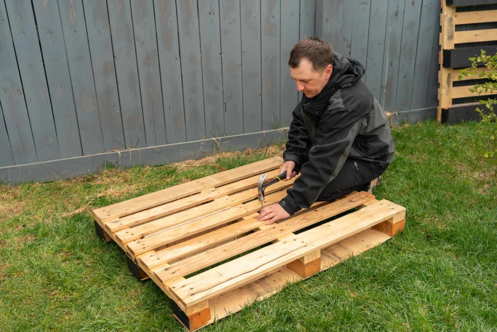 a man prepares pallets