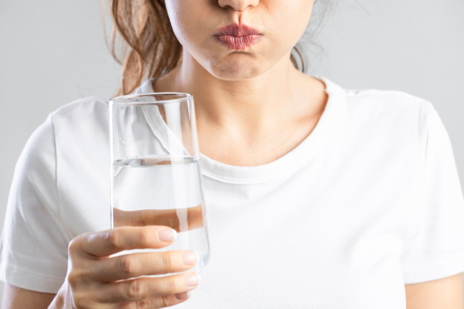 woman mouthwashing