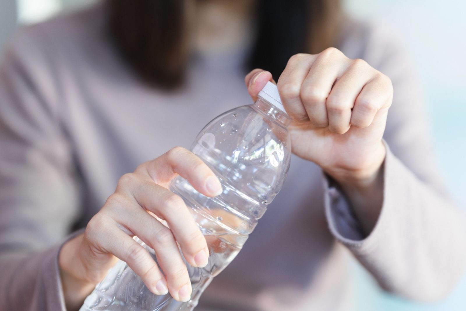 woman opening water bottle