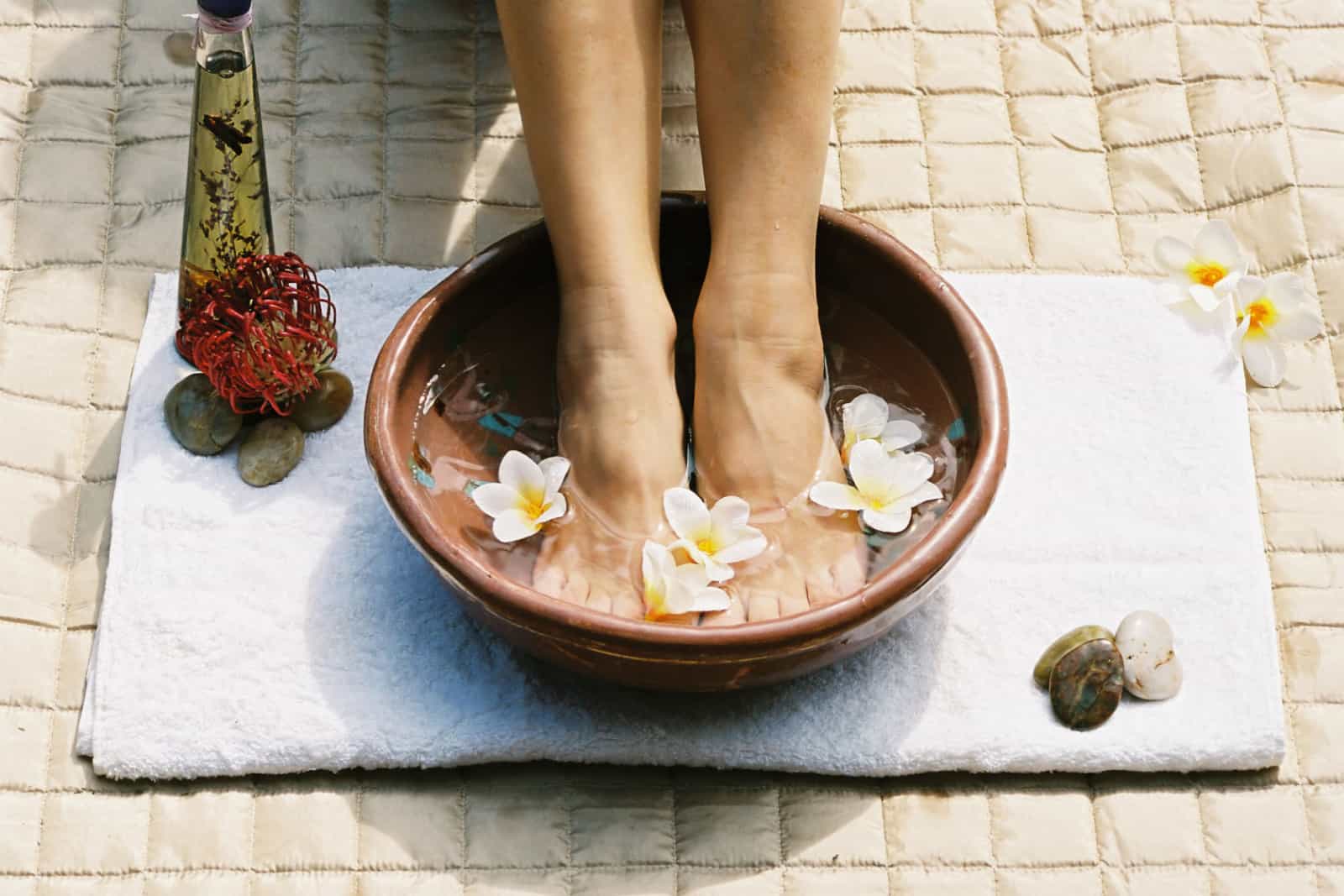woman prepares a foot soak with used tea bags