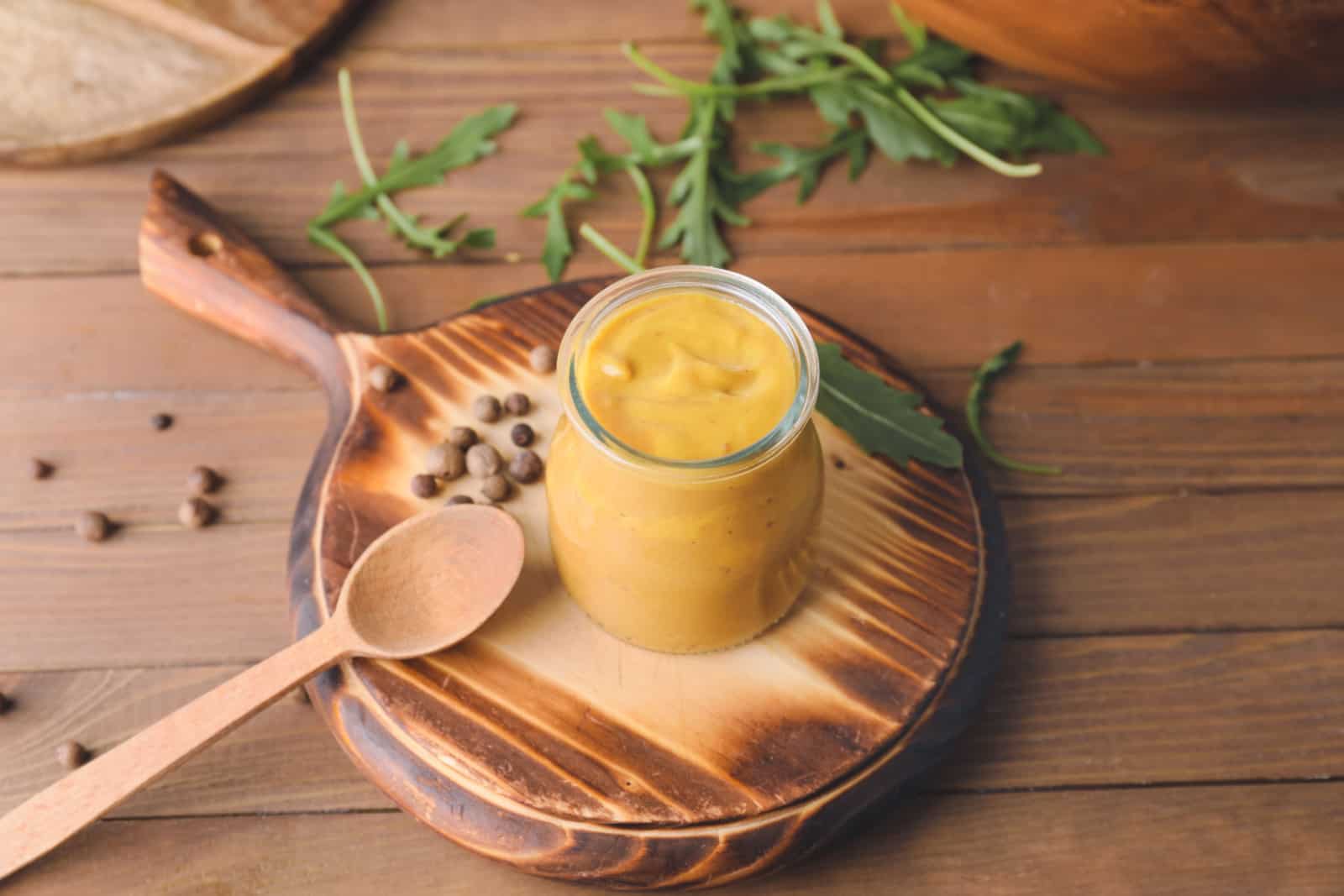 yellow mustard on a wooden table