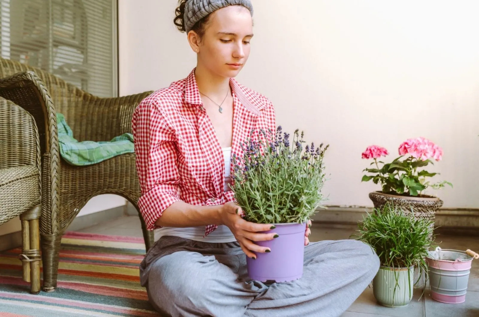young woman holding a lavender in a pot