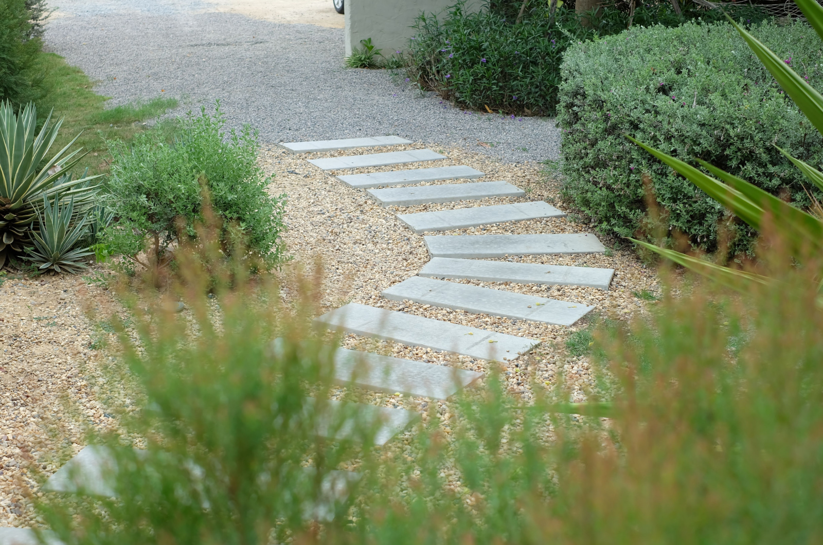 curved pathway surrounded by small stones