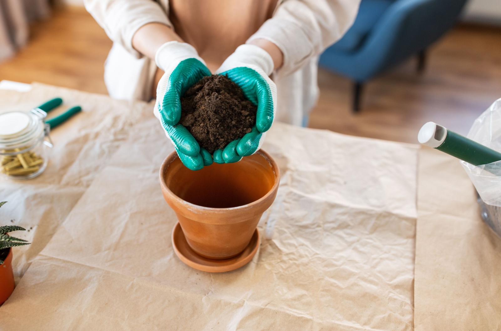 gardener adding soil to a pot