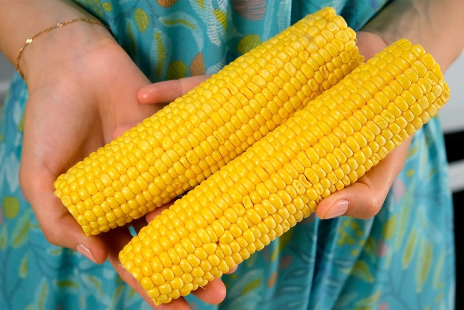 woman holding two corns