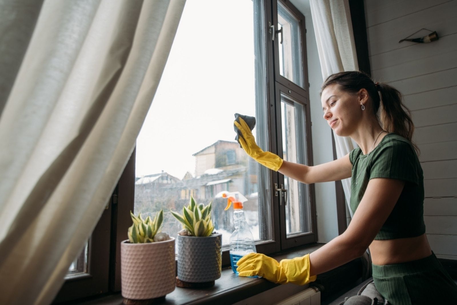 the woman cleans the windows
