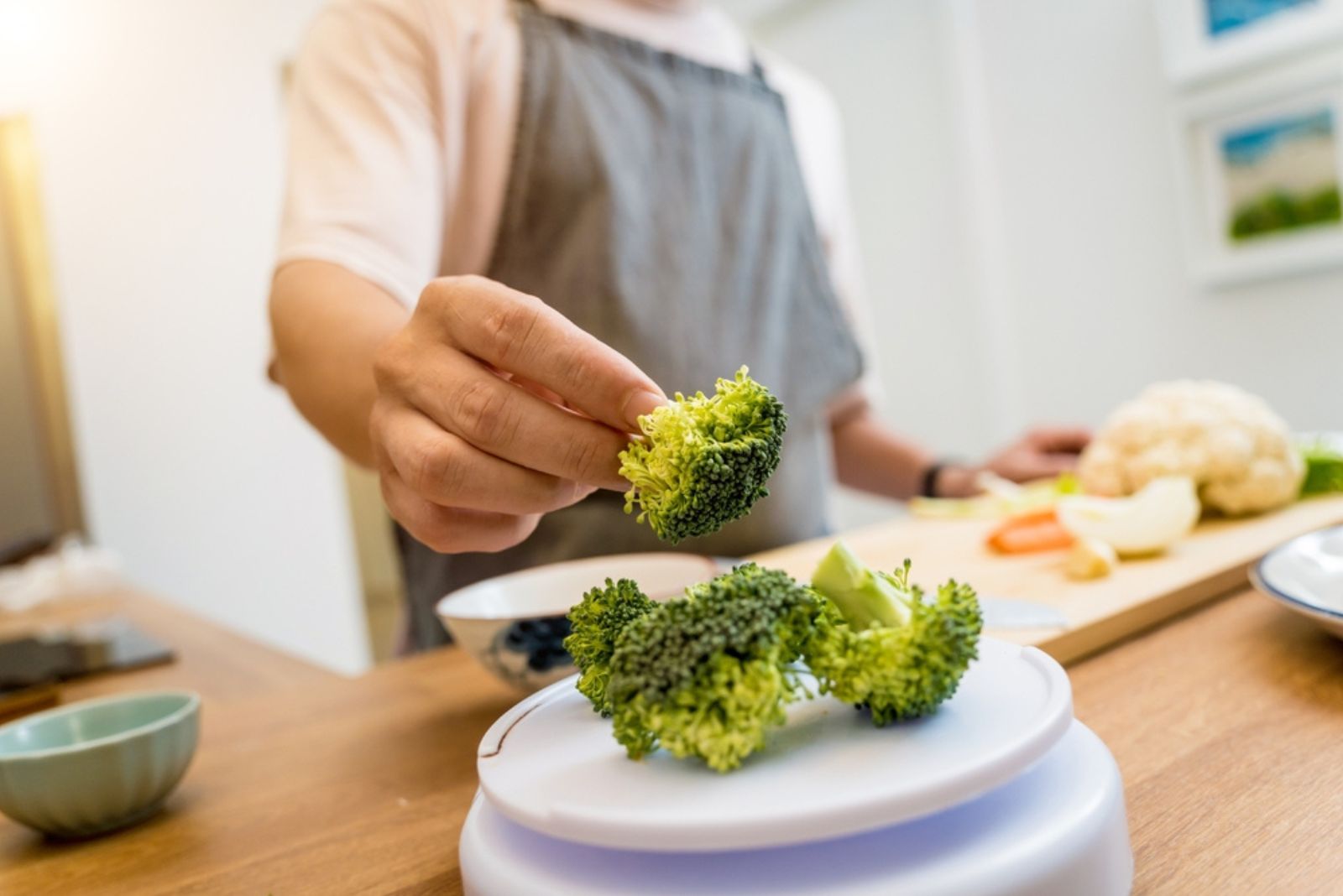 man taking a broccoli from plate