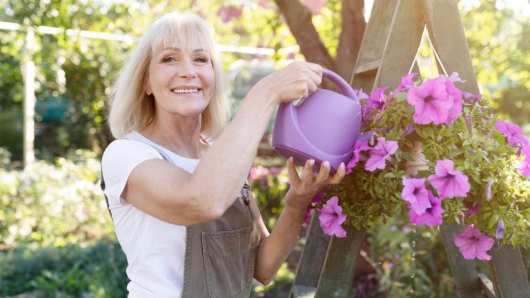 woman watering petunias