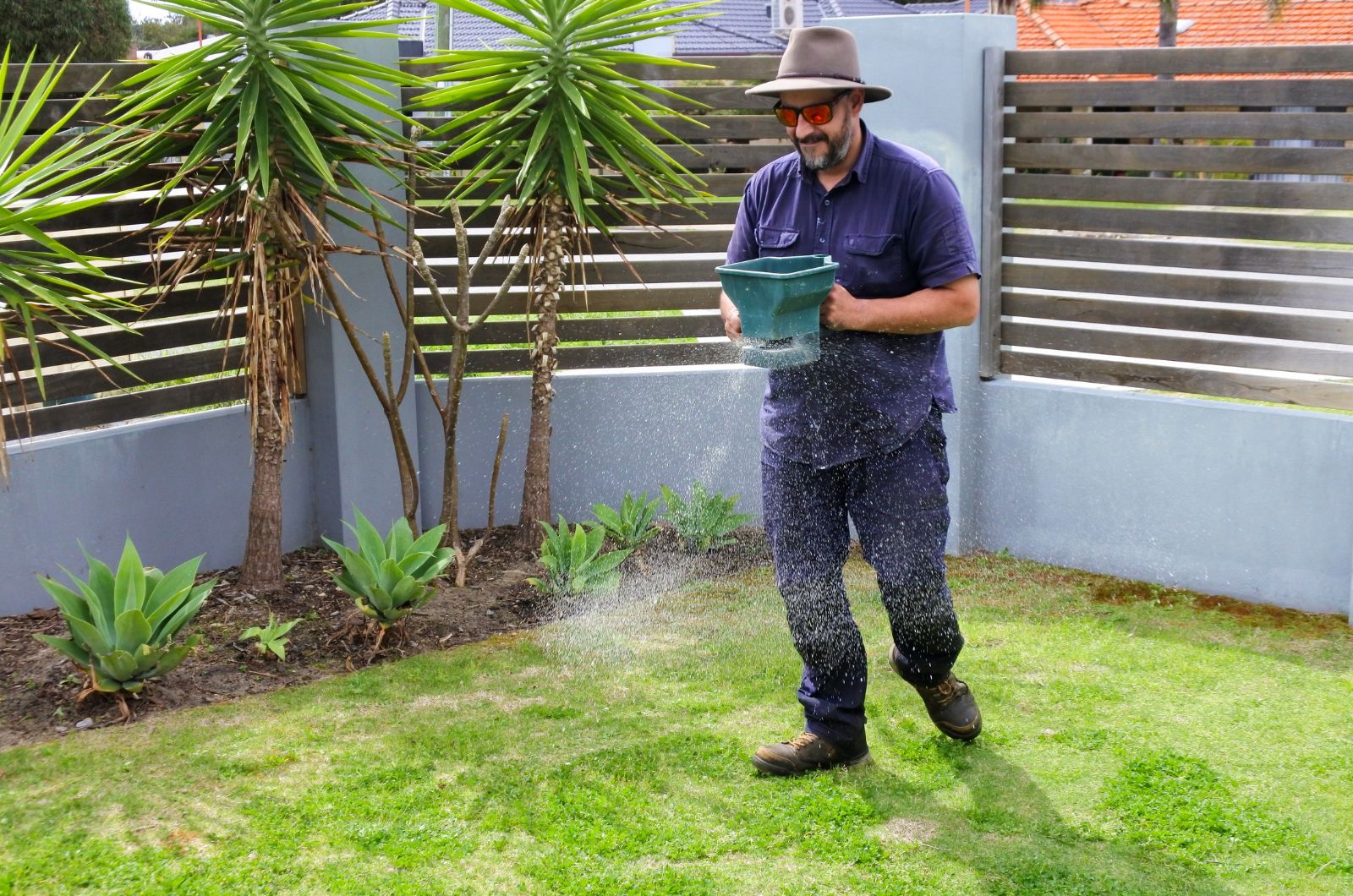 gardener spreading fertilizer