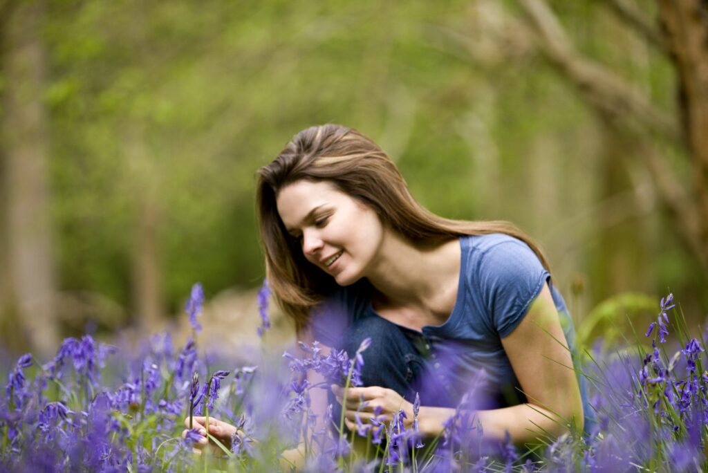 The girl is looking after the bluebell flowers