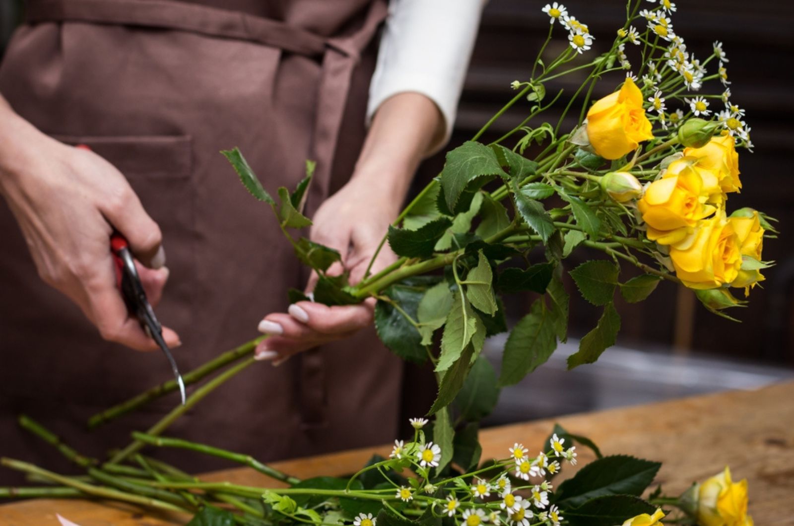 Florist cuts rose flowers with secateurs