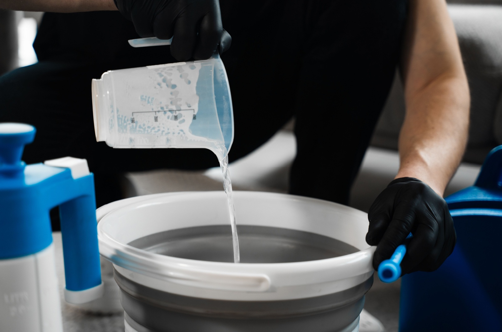 Pouring oxygen bleach mixture in the bucket