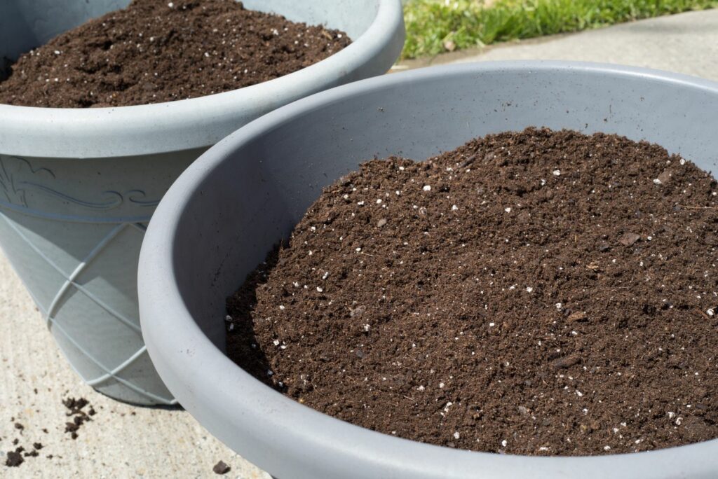 large gray pots with earth