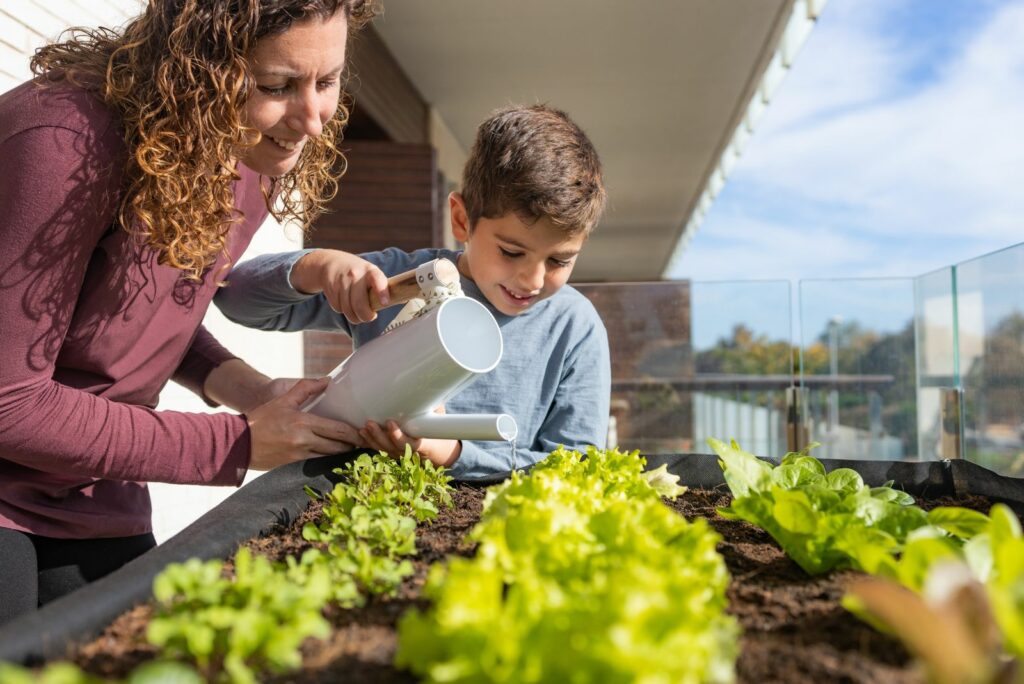 a boy with his mother eats arugula