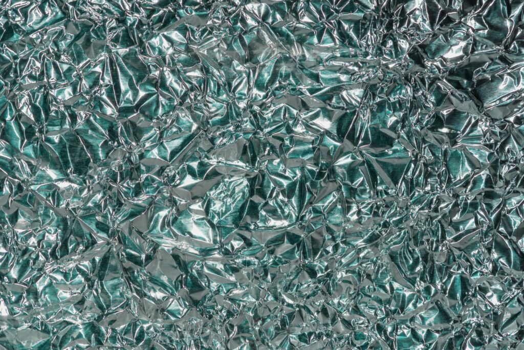 Abstract green color aluminum foil texture with shiny crumpled