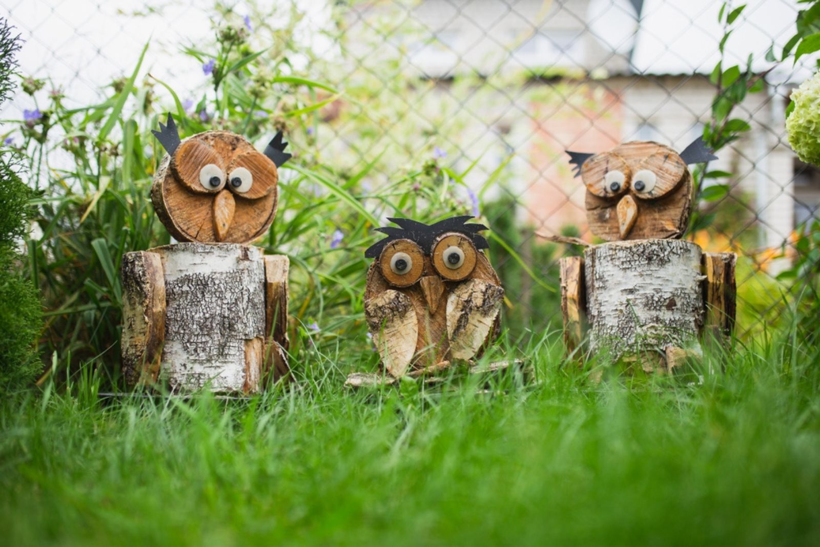 figurines of an owl from firewood and birch trimmings in a garden