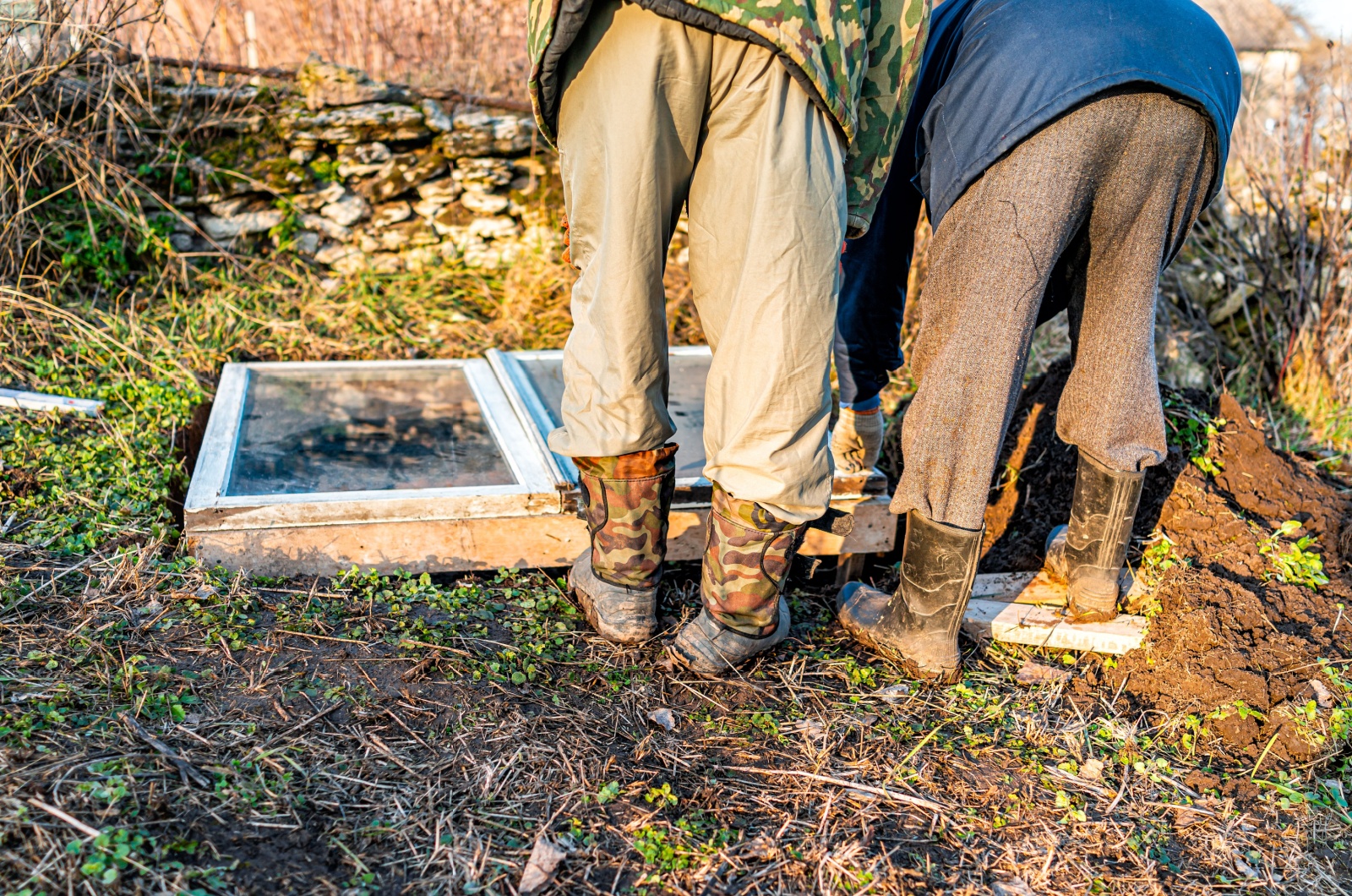 men working on raised bed cold frame