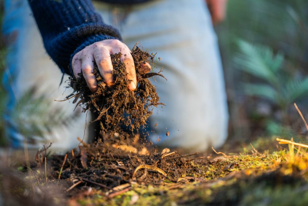 turning a compost pile in a community garden