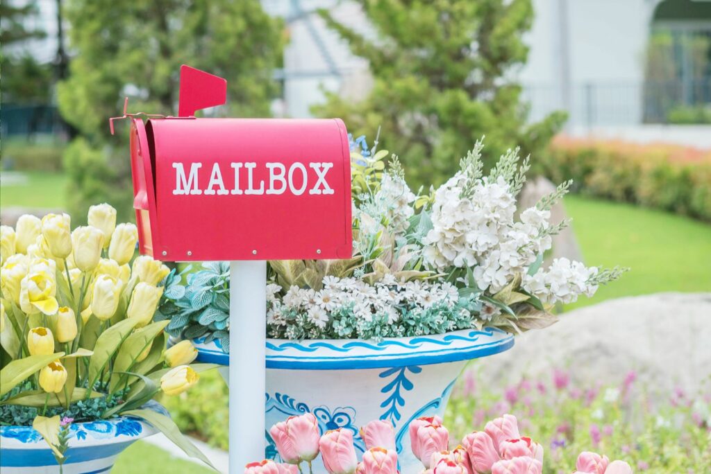 Closeup metal mailbox on garden view textured background