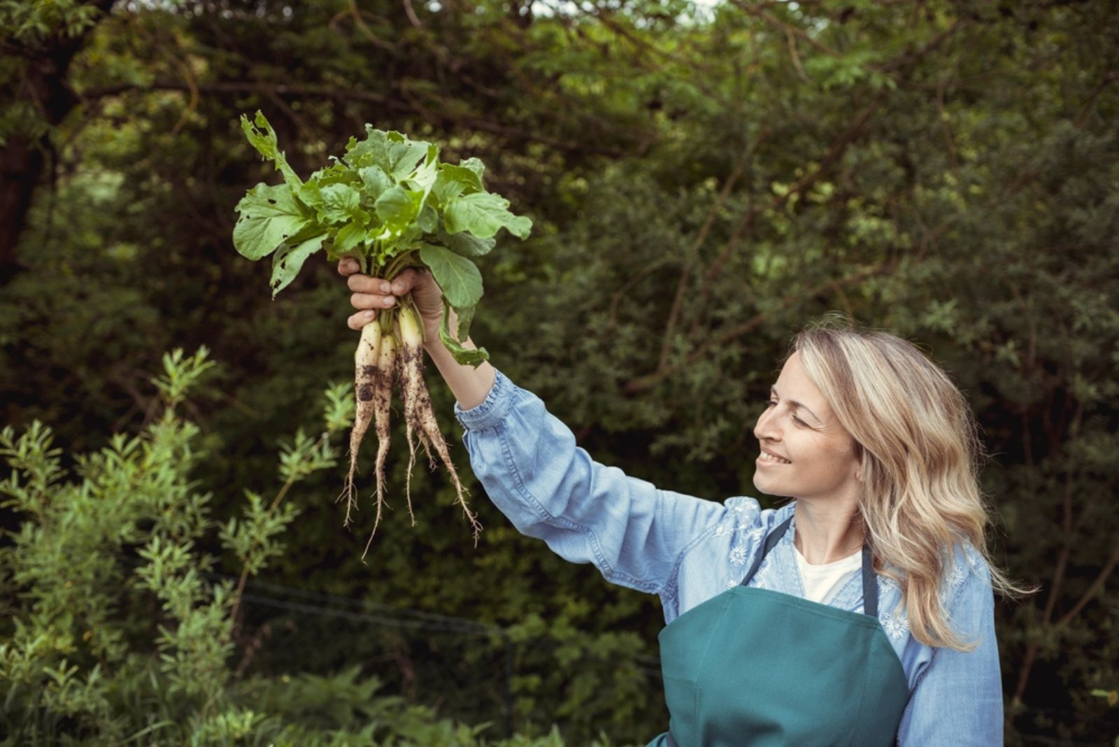 Woman holding horseradish in hand