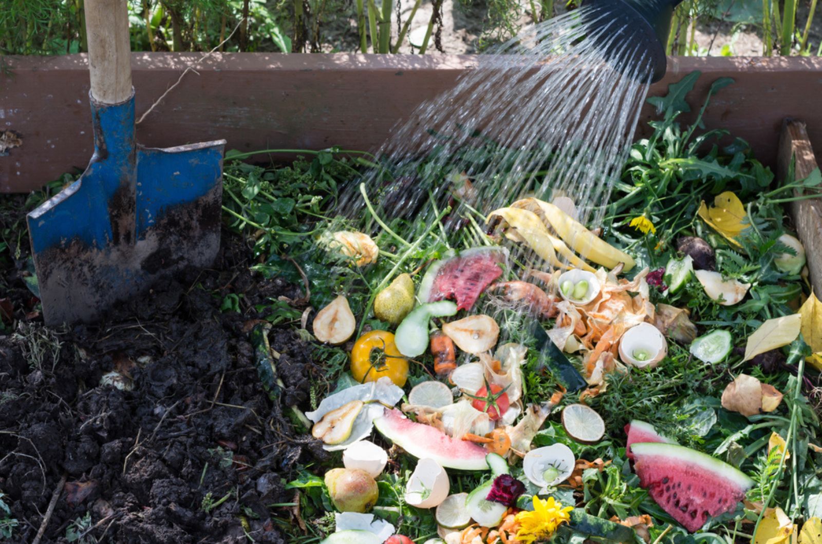 Compost box outdoors full with garden browns and greens