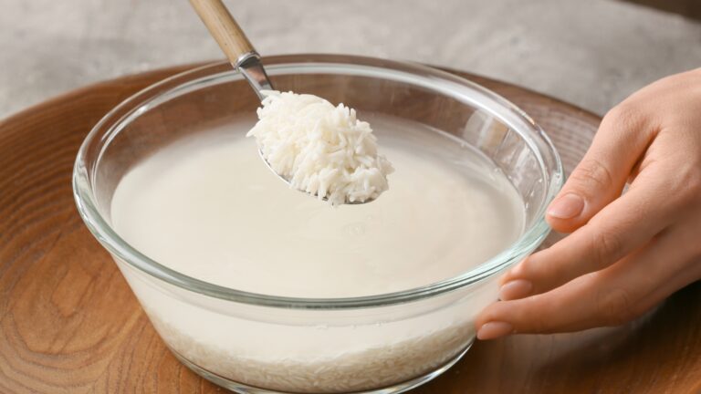 rice with water in bow and spoon with rice