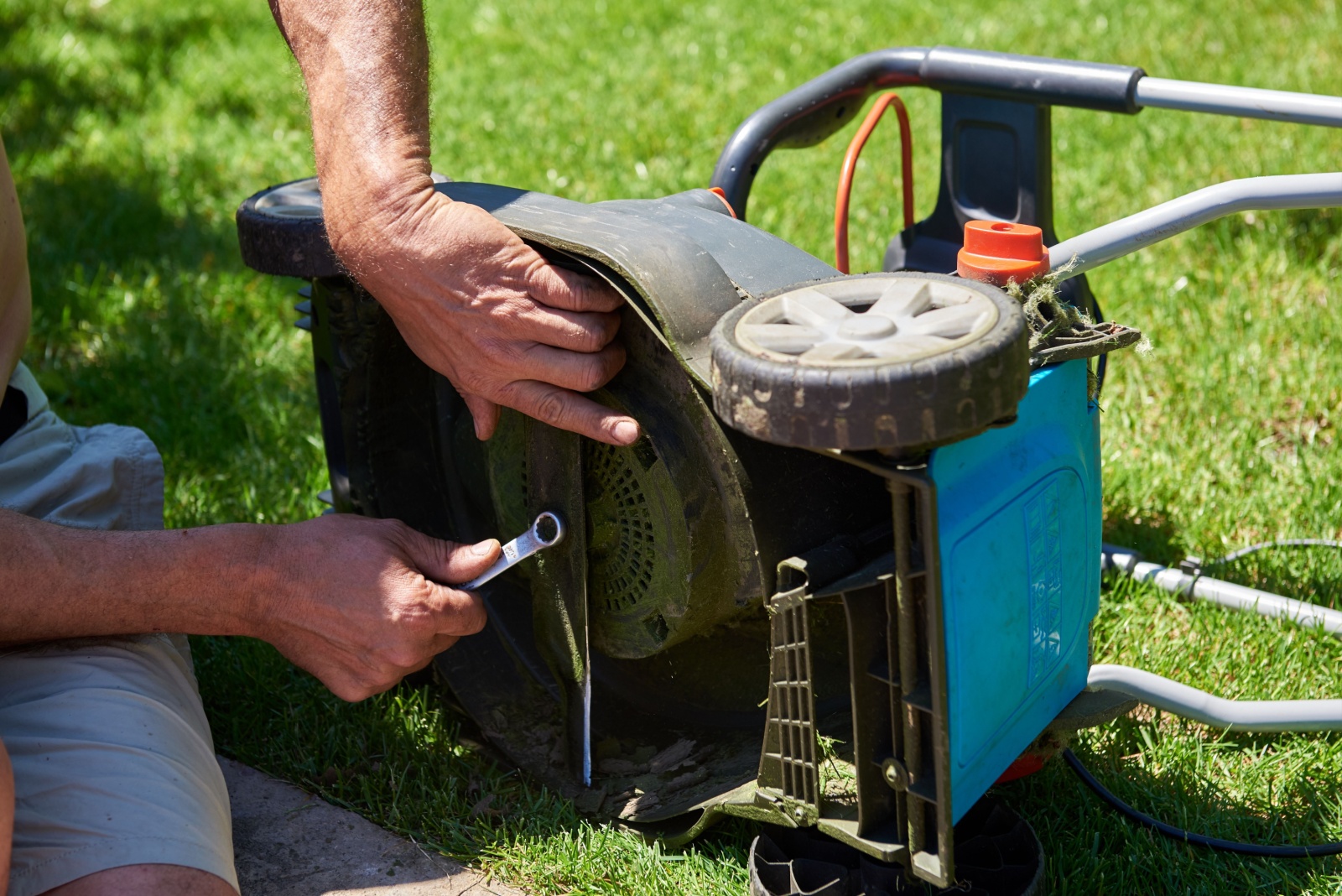 gardener sharpening mower blade