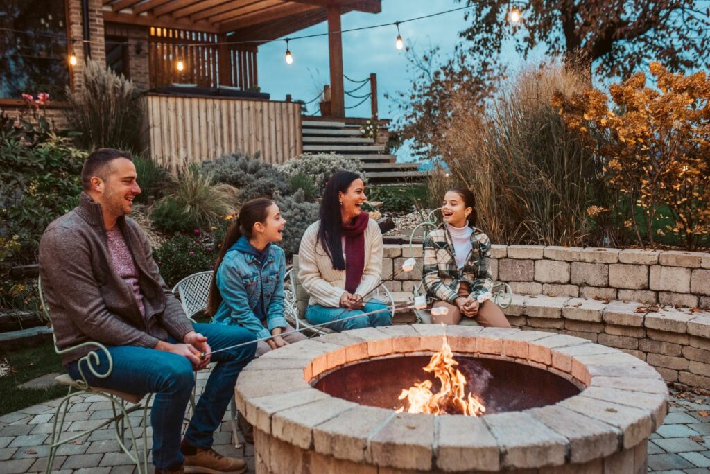 Family roasting marshmallows over open flame