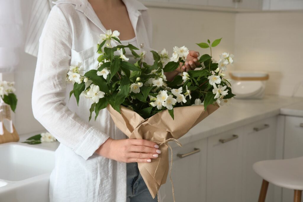 girl holding a bouquet of jasmine in her hand