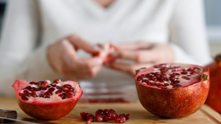 Young woman peel a pomegranate. Close up shot