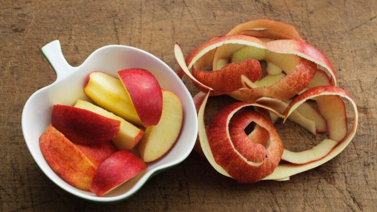 Apple Slices in Apple Shaped Bowl and Apples Peels