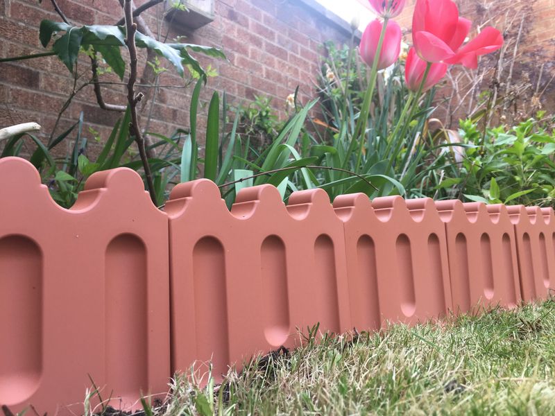 Install decorative ceramic or clay edging