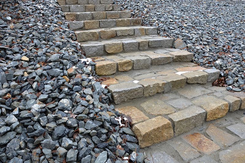 Scattered Small Pebbles On Sloped Areas