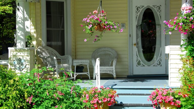 front porch adorned flowering hanging baskets