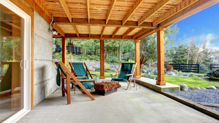 Ground level deck with chairs and door.